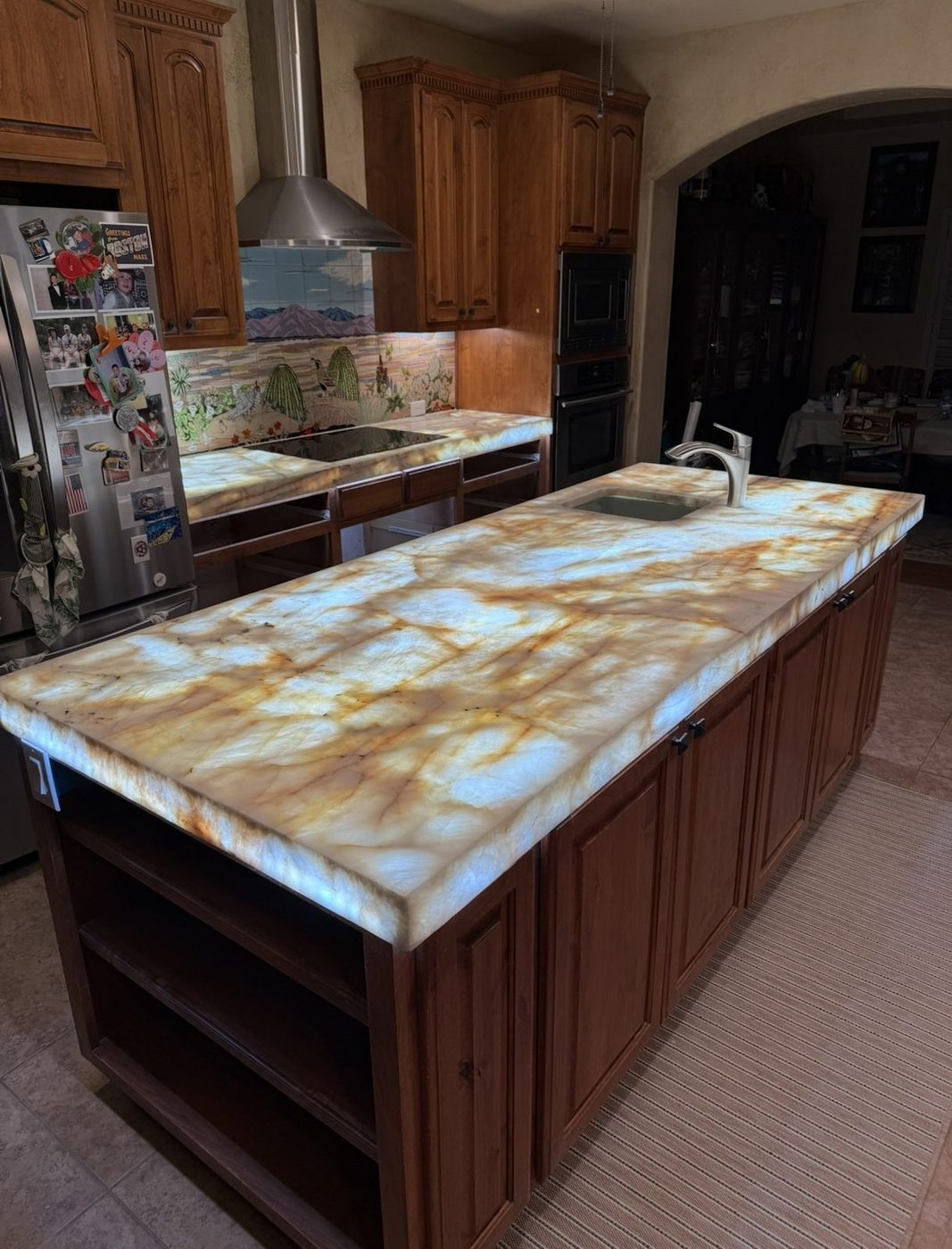 Backlit onyx kitchen island countertop with amber and gold veining, San Antonio TX