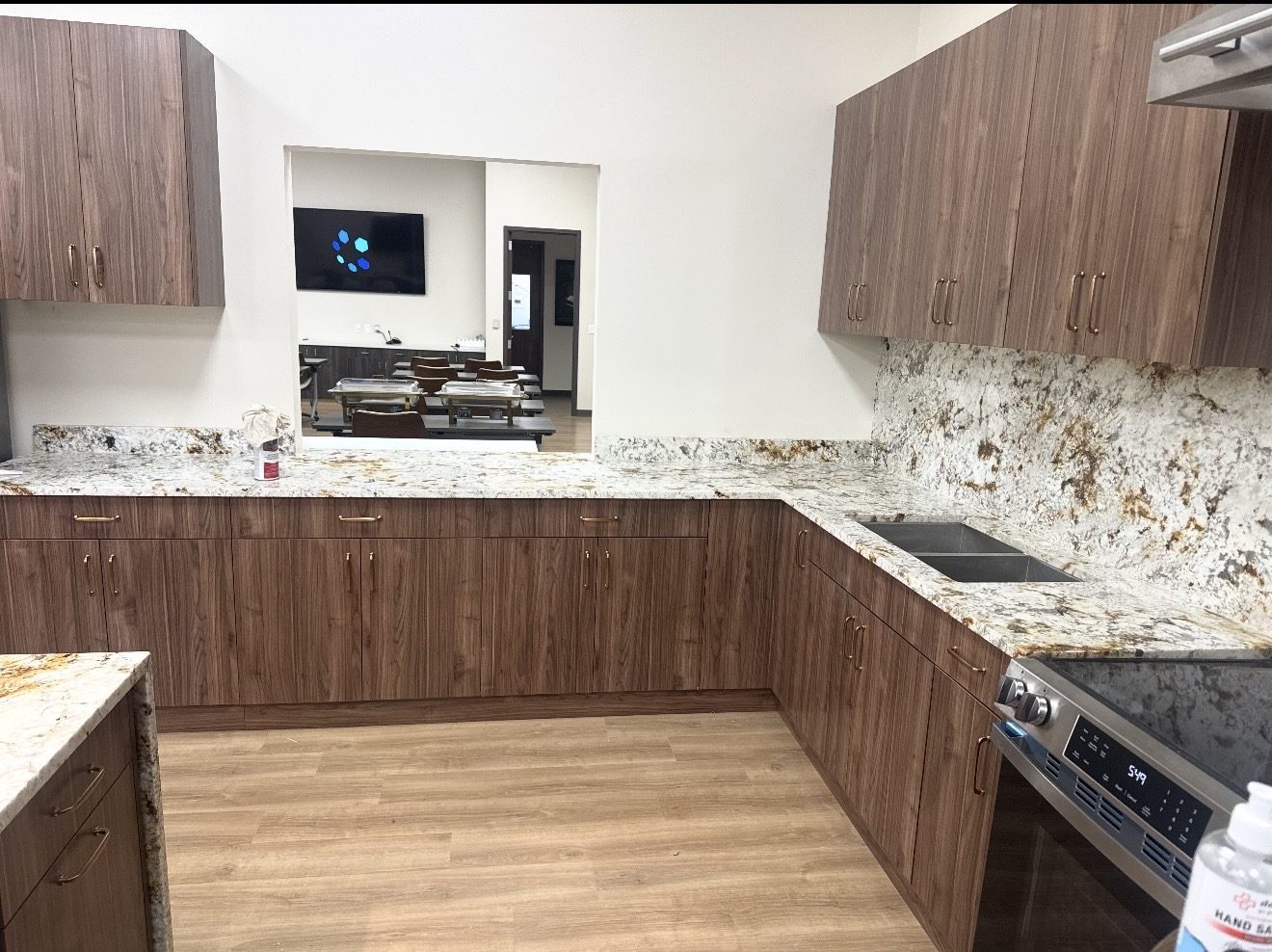 Granite countertops with full-height backsplash on walnut cabinets in a commercial kitchen, San Antonio TX