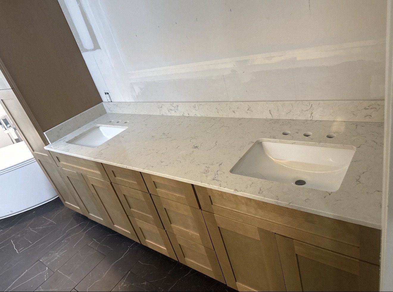 Quartz bathroom vanity top with backsplash on a long run of cabinets, San Antonio TX