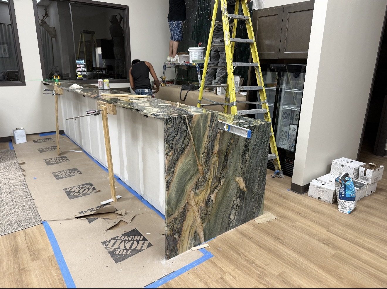 Granite Guru crew installing a green and gold quartzite bar top, San Antonio TX